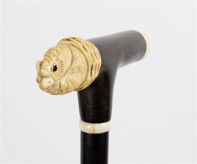 Lot 496 - An ebonised walking stick, the carved ivory...