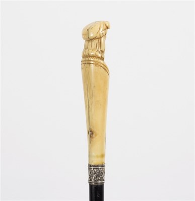 Lot 506 - An ebonised walking stick, the carved ivory...
