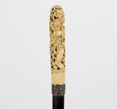 Lot 509 - An ebonised walking stick, the pierced and...