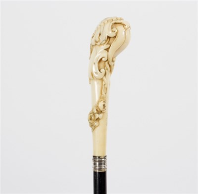 Lot 513 - An ebonised walking stick, the carved ivory...