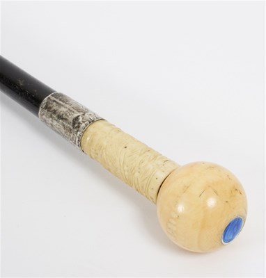 Lot 519 - An ebonised walking stick, the ivory ball...