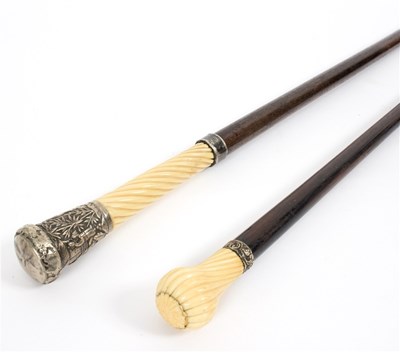 Lot 523 - An ebonised walking stick with spirally ribbed...