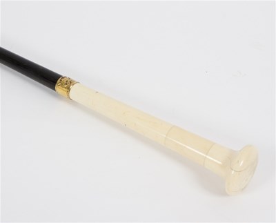 Lot 526 - An ebonised walking stick with tapered ivory...