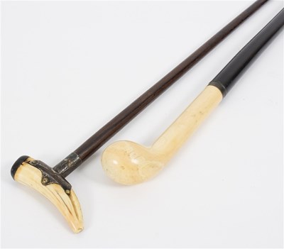 Lot 529 - An ebonised walking stick with club shaped...