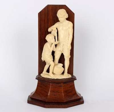 Lot 833 - A French carved ivory figure of a child...