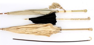 Lot 860 - A black lace parasol, the ivory handle carved...