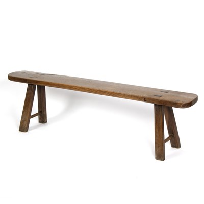 Lot 877 - An elm form (stool) on splay supports, 176cm...