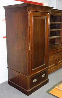 Lot 906 - A mahogany linen press, the panel door now...