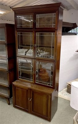Lot 917 - A mahogany three-section bookcase, each...