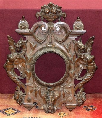 Lot 927 - A carved oak frame with baskets of flowers...