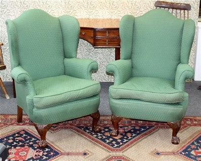 Lot 928 - A pair of wing back upholstered armchairs, on...