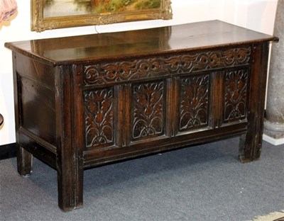 Lot 930 - An oak coffer with twin panelled top and...