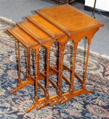 Lot 939 - A nest of four burr walnut tables, crossbanded...