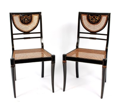 Lot 942 - A pair of ebonised cane seat and back chairs...