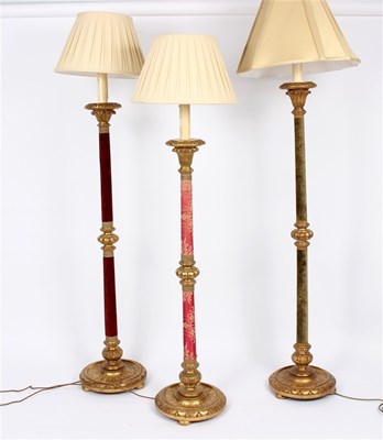 Lot 944 - Three Italian style standard lamps with gilded...