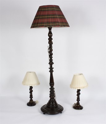 Lot 999 - A standard lamp and two table lamps on twist...