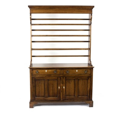 Lot 1030 - A narrow oak dresser, the open rack above a...