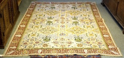 Lot 1048 - A floral patterned rug within a red ground...