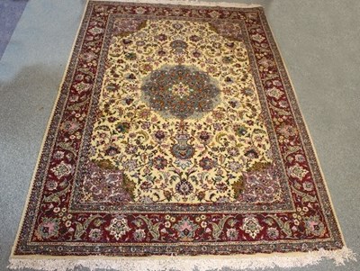 Lot 1051 - A modern Persian carpet with central floral...