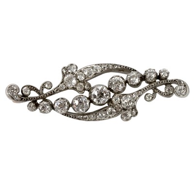 Lot 17 - A diamond brooch of scrolling form, the...