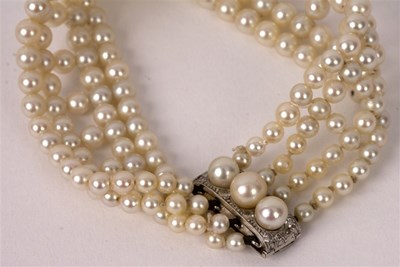 Lot 19 - A four-row pearl bracelet with pearl and...