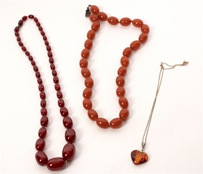Lot 24 - A single row of cherry amber beads, the...