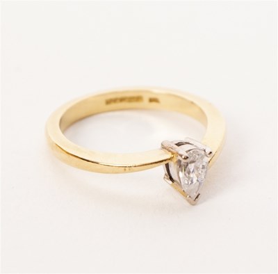 Lot 27 - A pear-shaped diamond solitaire ring set in...