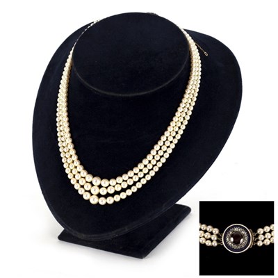 Lot 42 - A three-row cultured pearl necklace joined by...