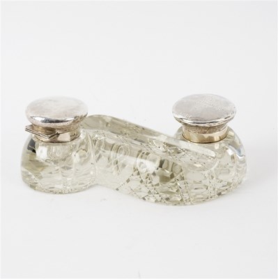 Lot 101 - A cut glass inkwell of S shape, the silver...