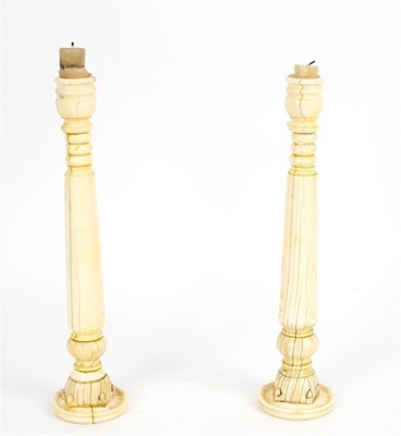Lot 145 - A pair of Anglo-Indian ivory candlesticks,...