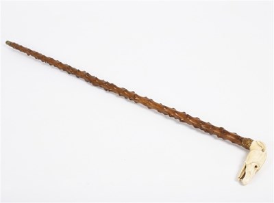 Lot 179 - A knotted wood walking stick with brass collar...