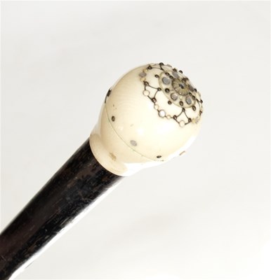 Lot 192 - An ebonised walking stick, the ivory knob...