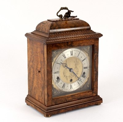 Lot 445 - A walnut cased mantel clock by Elliott, the...