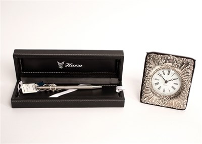 Lot 446 - A Quartz clock in a silver fronted easel back...