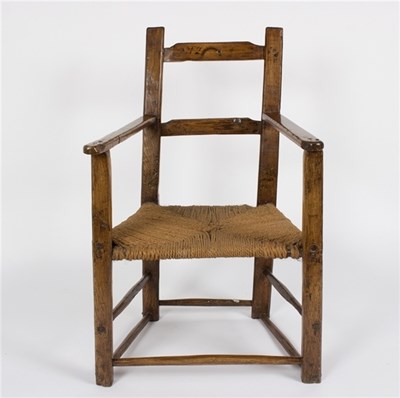 Lot 531 - A primitive oak 18th Century chair with strung...