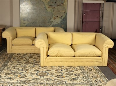 Lot 575 - A pair of upholstered two-seater sofas with...