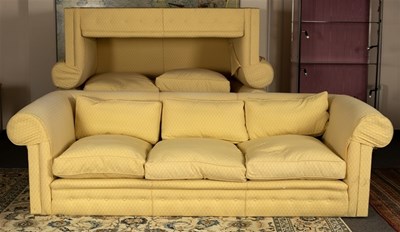 Lot 576 - A three-seater sofa with button divan base,...