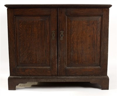 Lot 591 - An oak cupboard enclosed by panel doors, 96cm...