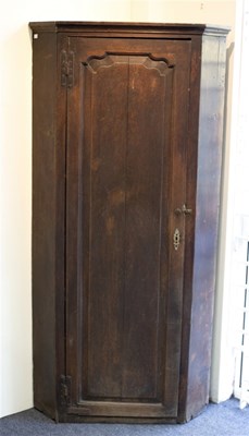 Lot 601 - A George III oak floor standing corner...