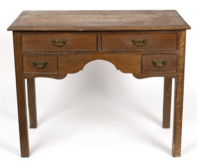 Lot 602 - An oak lowboy fitted four drawers above a...