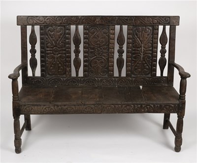 Lot 604 - A 17th Century style oak settle, with carved...