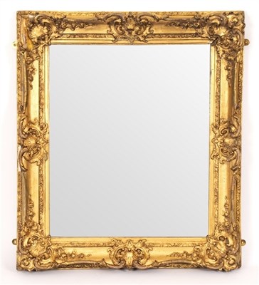 Lot 606 - A Victorian gilt-framed mirror with shell and...