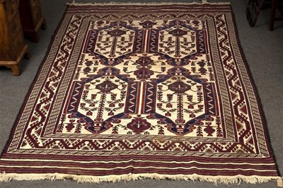 Lot 617 - An Afghan rug decorated vases of flowers...