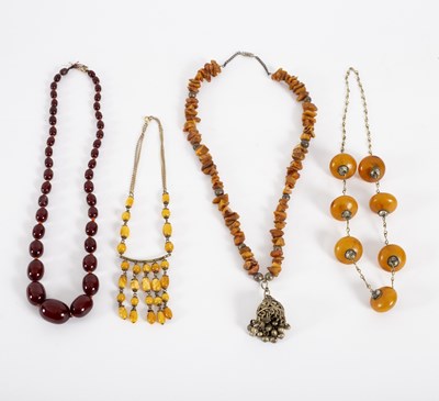 Lot 21 - A single row of graduated cherry amber beads...