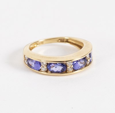 Lot 23 - A tanzanite and diamond half hoop ring, the...