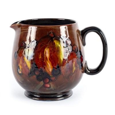 Lot 58 - Moorcroft, a leaf and berries pattern jug,...