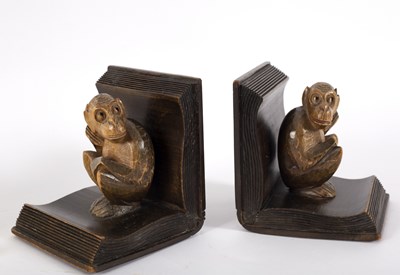 Lot 101 - A pair of wooden bookends, each carved as a...