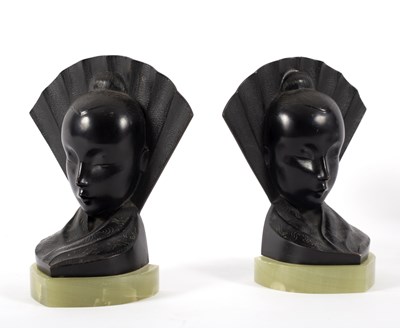 Lot 102 - A pair of onyx and black metal bookends in the...