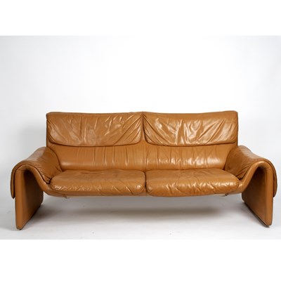 Lot 173 - De Sede, Switzerland, a tan leather sofa,...