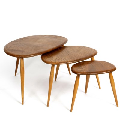 Lot 199 - Ercol, a nest of three beech Pebble tables, on...